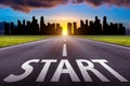 Start text on long road. A long straight road and cityscape at sunset Royalty Free Stock Photo