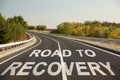 Start to live without alcohol addiction. Phrase ROAD TO RECOVERY on asphalt highway Royalty Free Stock Photo