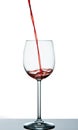 Start to pour red wine into wine glass Royalty Free Stock Photo