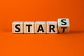 Start to stars symbol. Turned a wooden cube and changed the word `start` to `stars`. Beautiful orange background, copy space. Royalty Free Stock Photo