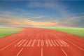 Start to Success written on running track written on Running track with green grass and blue sky white cloud background.