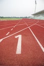 Start track number 1 on red running track. Royalty Free Stock Photo