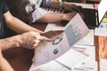 Start up business. people holding pen ,Team work meeting point to discuss the graph up and down of economy and work on table. Royalty Free Stock Photo