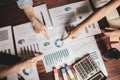 Start up business. people holding pen ,Team work meeting point to discuss the graph up and down of economy and work on table. Royalty Free Stock Photo