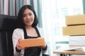 Start up business woman holding delivery boxes ready to send Royalty Free Stock Photo