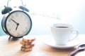 Start up concept with coffee cup, cookies and alarm clock Royalty Free Stock Photo