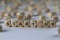 Start up - cube with letters, sign with wooden cubes