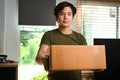 Start up small business owner holding cardboard box preparing sending to customers. Royalty Free Stock Photo