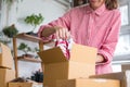 start up small business owner packing shoes in the box at workplace. freelance woman entrepreneur SME seller prepare product for