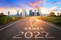 Start 2022 written on highway road in the middle of empty asphalt road of asphalt road at sunset.Concept of planning and challenge Royalty Free Stock Photo