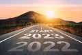 Start 2023 written on highway road in the middle of empty asphalt road of asphalt road at sunset.Concept of planning and challenge Royalty Free Stock Photo