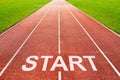 Start written on starting line on of running track of sports field Royalty Free Stock Photo