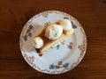 Start your day with homemade Gourmet pastry vanilla roll cake top with cream cheese on vintage plate on wood table in the cafe wi Royalty Free Stock Photo