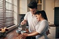 Start your day with love and coffee. a young couple pouring their morning coffee. Royalty Free Stock Photo