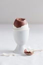 Chocolate egg on white eggstand holder Royalty Free Stock Photo