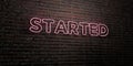 STARTED -Realistic Neon Sign on Brick Wall background - 3D rendered royalty free stock image