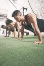 We started simple and worked our way up. a fitness group doing push-ups at the gym.