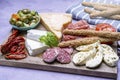 Starter with Cured meat and cheese traditional Spanish tapas - jamon serrano, cheese - served on wooden board olives and bread Royalty Free Stock Photo