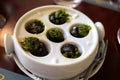 Starter dish in traditional restaurants on Burgundy, snails cooked with butter, garlic and herbs, France