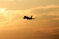 Starting airplane in front of the evening sun