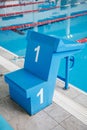 Starting block, number 1, swimming pool with an empty race track. Sport swimming