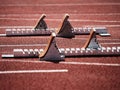 Starting blocks on light red running tracks lanes at track and field stadium Royalty Free Stock Photo