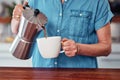 Starting her morning with a little bit of caffeine. an unrecognizable senior woman pouring herself a cup of coffee while Royalty Free Stock Photo