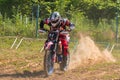 Starting line in motocross competitions. Thick dust rises behind the wheels.