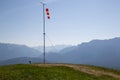Starting point near Garmisch Partenkirchen of paragliders with red and white windsocks. In the background mountain peaks in the Ge Royalty Free Stock Photo