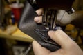 Starting a Box Stitch on Black Leather Royalty Free Stock Photo