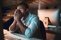 Starting to fade. a young male designer looking stressed while working on his computer in the office. Royalty Free Stock Photo