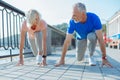 Cheerful senior couple being in starting position