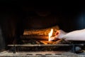 Starting up a fire inside a chimney with lighter cubes Royalty Free Stock Photo