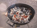 Starting up garden barbeque. Heating up charcoal stage. Burning coal. Summer time activity, Food preparation in a park or backyard Royalty Free Stock Photo