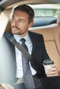 He starts every day with a fresh cup of coffee. a handsome businessman drinking coffee while driving into work. Royalty Free Stock Photo