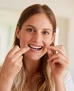 It starts with healthy habits. Portrait of a young woman flossing her teeth at home. Royalty Free Stock Photo