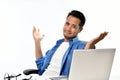 Startup business man sitting in relaxed posture with hands raised after having work done easily