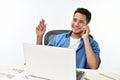 Startup business man smiling while talking on the phone and having fun at work Royalty Free Stock Photo