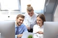 Startup business team on meeting in modern bright office interior brainstorming, working on tablet and PC computers Royalty Free Stock Photo