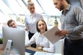 Startup business team on meeting in modern bright office interior brainstorming, working on tablet and PC computers Royalty Free Stock Photo