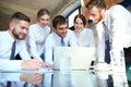 Startup business team on meeting in modern bright office interior and working on laptop Royalty Free Stock Photo