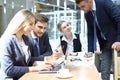 Startup business team on meeting in modern bright office interior and working on laptop Royalty Free Stock Photo