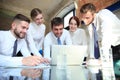 Startup business team on meeting in modern bright office interior and working on laptop Royalty Free Stock Photo