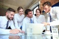 Startup business team on meeting in modern bright office interior and working on laptop Royalty Free Stock Photo