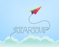 Startup concept with colorful paper plane rising through the sky