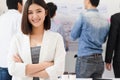 Startup diversity teamwork brainstorming meeting concept. Successful happy businesswoman standing and looking camera and smile Royalty Free Stock Photo