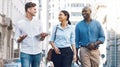 Startup entrepreneur, friends or corporate workers discuss project while walking in the city. Diversity, happy and Royalty Free Stock Photo