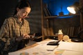 Startup small business entrepreneur Asian girl small business owner using tablet at late evening, work at home at night