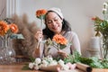 Startup, small business, flower shop. Older florist putting a flower on a vase