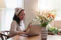 Startup, small business, flower shop. Older florist putting a flower on a vase